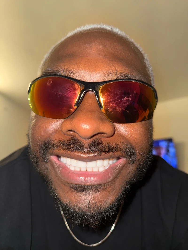 A-WIRE smiling in orange sunglasses